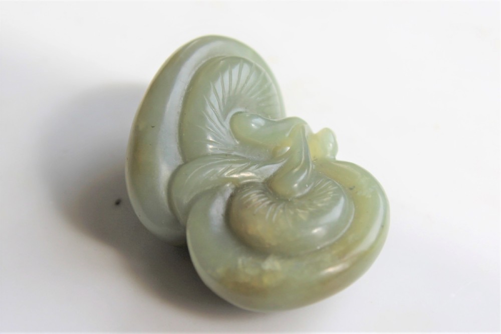 A well carved Chinese green jade Lingzhi Fungus pendant or netsuke Circa 1880 to 1920 View VII