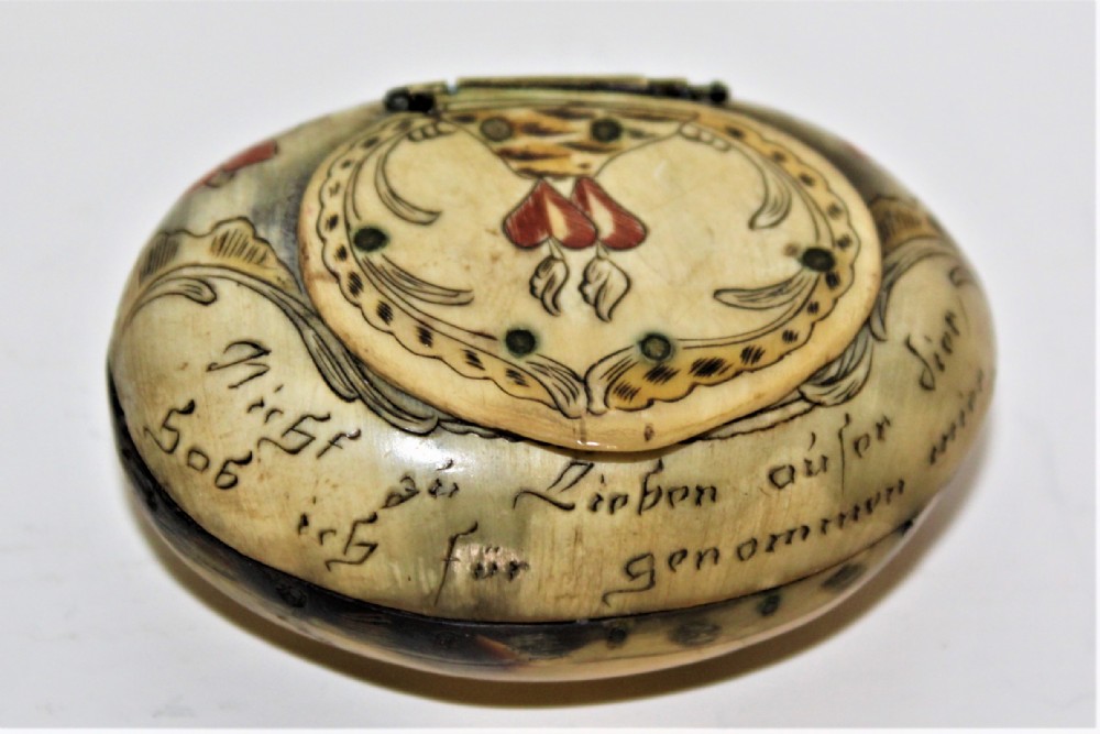 A small charming scrimshawed horn snuff box depicting a couple under a tree holding hands German Circa 1800 to 1850