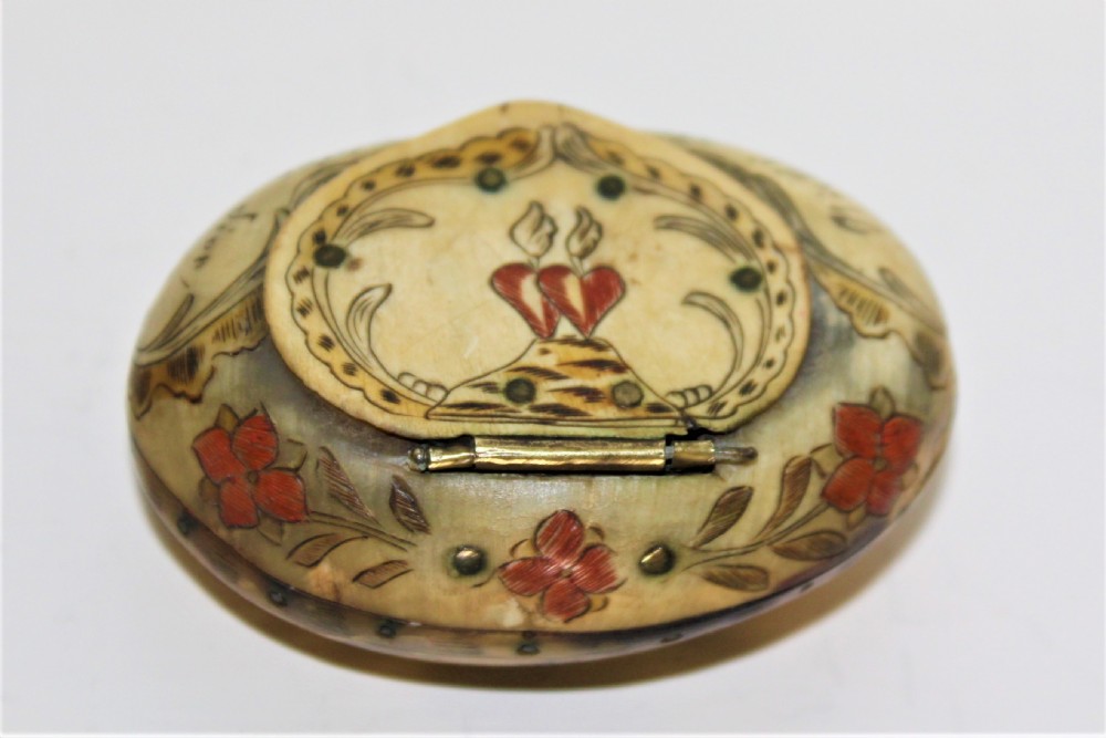 A small charming scrimshawed horn snuff box depicting a couple under a tree holding hands German Circa 1800 to 1850 View II