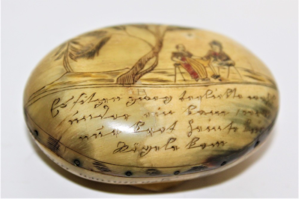 A small charming scrimshawed horn snuff box depicting a couple under a tree holding hands German Circa 1800 to 1850 View V