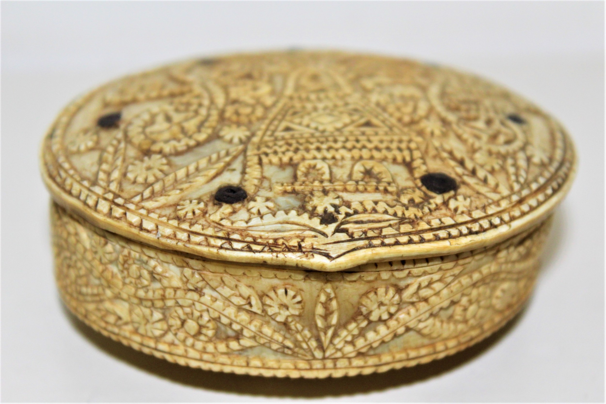 A rare 15th century carved bone hinged box dated 1488 of oval form with overall carved decoration 