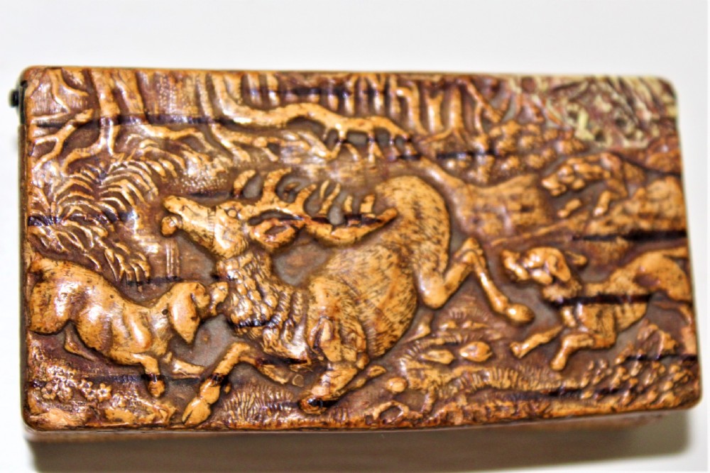 A 19th century Swedish relief carved birch wood snuffbox depicting a hunting scene 