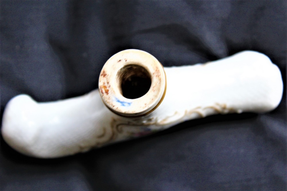 A white porcelain T-shaped walking stick handle decorated with hand-painted polychrome flowers and gilded scrolling scrollwork. View IV