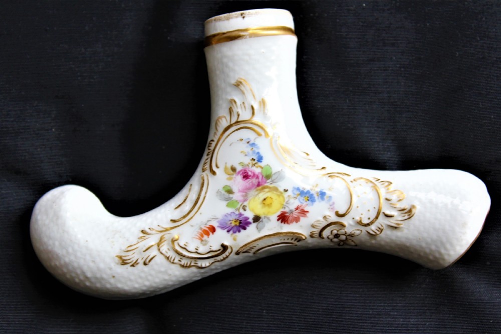 A white porcelain T-shaped walking stick handle decorated with hand-painted polychrome flowers and gilded scrolling scrollwork. View V
