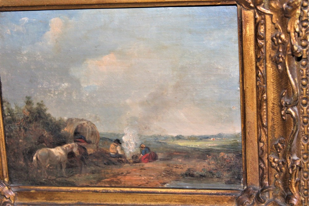 A small and charming well painted oil on panel depicting a couple sitting by a camp fire by a lake with a horse and wagon in the background  View III