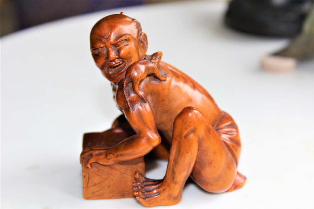 A superb and finely carved boxwood Okimono of the rat catcher Japanese Circa 1880 