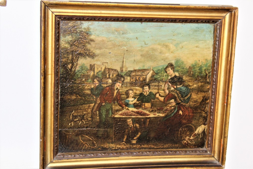 An antique oil painting on a wood panel depicting figures, children, and dogs in a rural village setting, enclosed in a gilded frame.