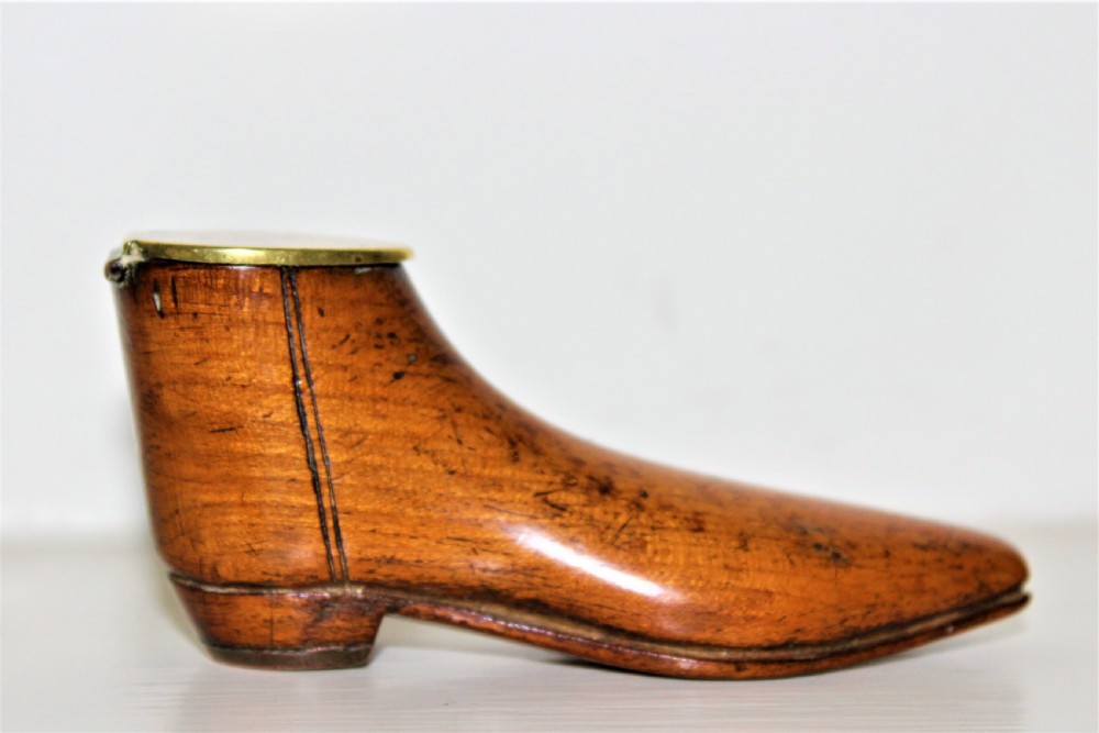 A very fine and tactile Georgian fruitwood snuff box in the shape of a shoe with a brass hinged lid and a brass horse shoe 