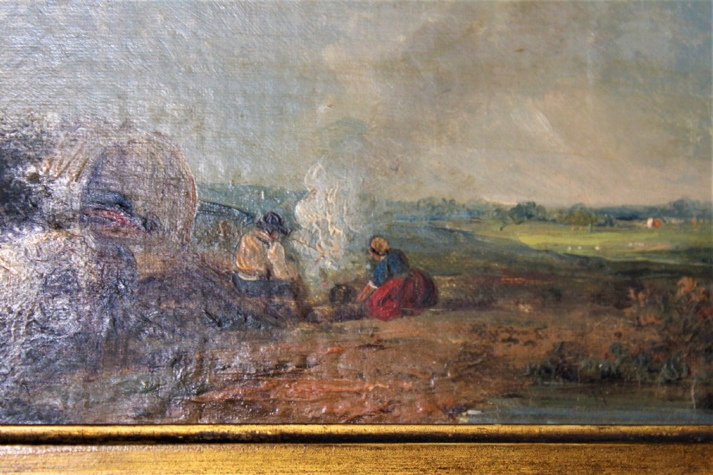 An antique oil painting on wood panel depicting figures and a horse beside a campfire, framed in an ornate gilt gesso frame. View V