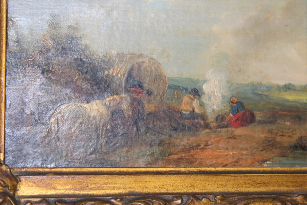 An antique oil painting on wood panel depicting figures and a horse beside a campfire, framed in an ornate gilt gesso frame. View VI