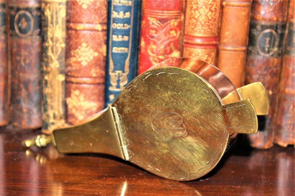 An early 19th-century English brass and copper novelty snuff box designed in the shape of miniature fireplace bellows with hand-engraved detailing. View III