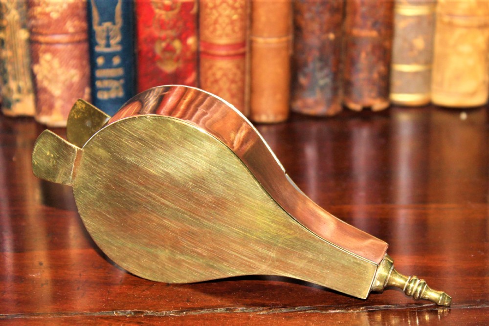 An early 19th-century English brass and copper novelty snuff box designed in the shape of miniature fireplace bellows with hand-engraved detailing. View IV