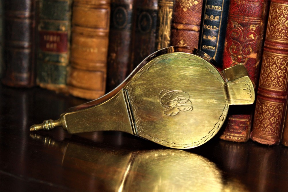 An early 19th-century English brass and copper novelty snuff box designed in the shape of miniature fireplace bellows with hand-engraved detailing. View V