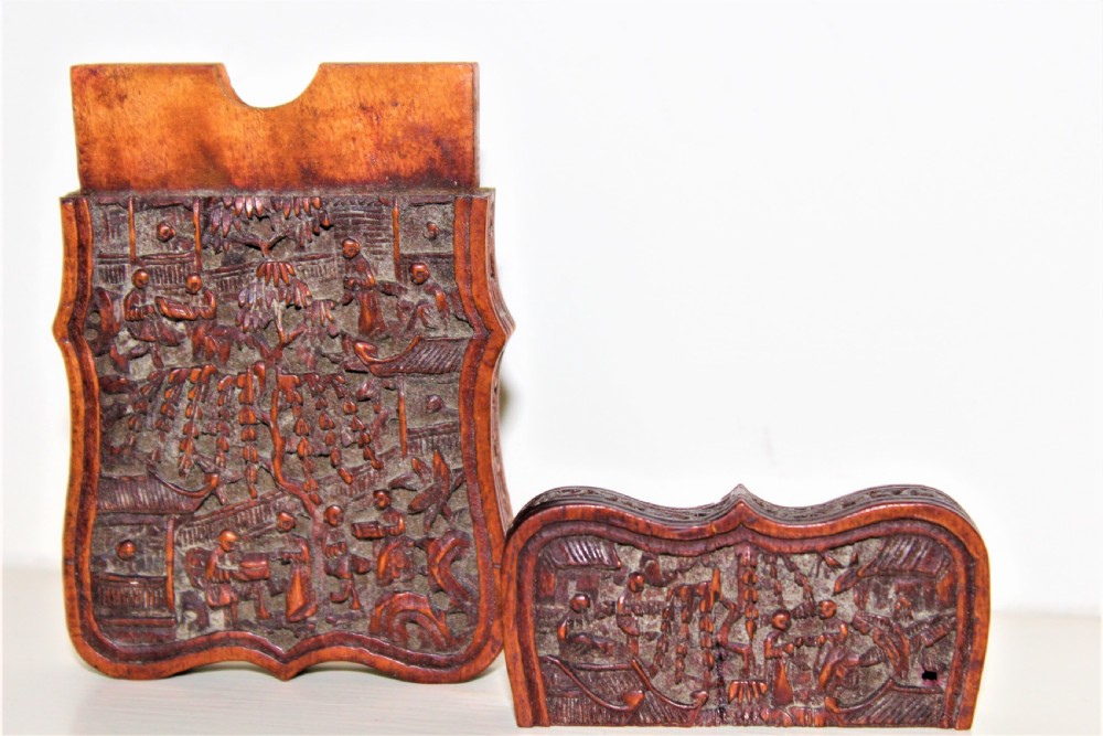 An antique Chinese carved wood card case featuring relief carvings of human figures and pavilions within a garden landscape. View VI