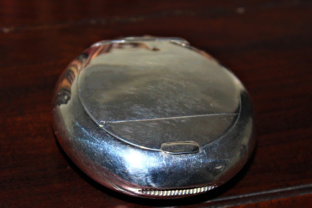A rare silver circular tobacco box with a concealed vesta case in the lid  View VI