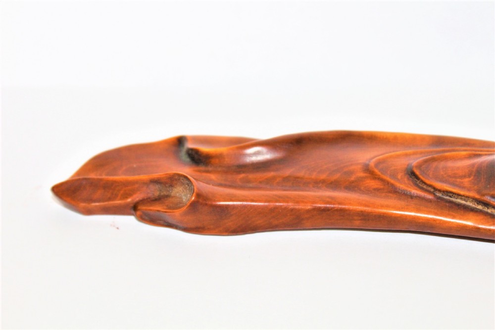 A carved Chinese boxwood wrist rest depicting a reclining bearded sage with flowing robes and a gourd bottle. View VII