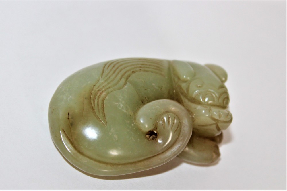 A finely carved Chinese celadon jade cat 