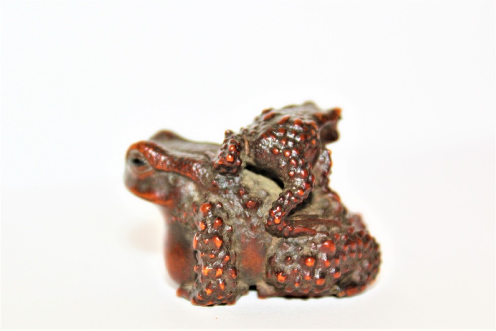 A finely carved small boxwood netsuke /okimono of two Toads signed Masanao View II