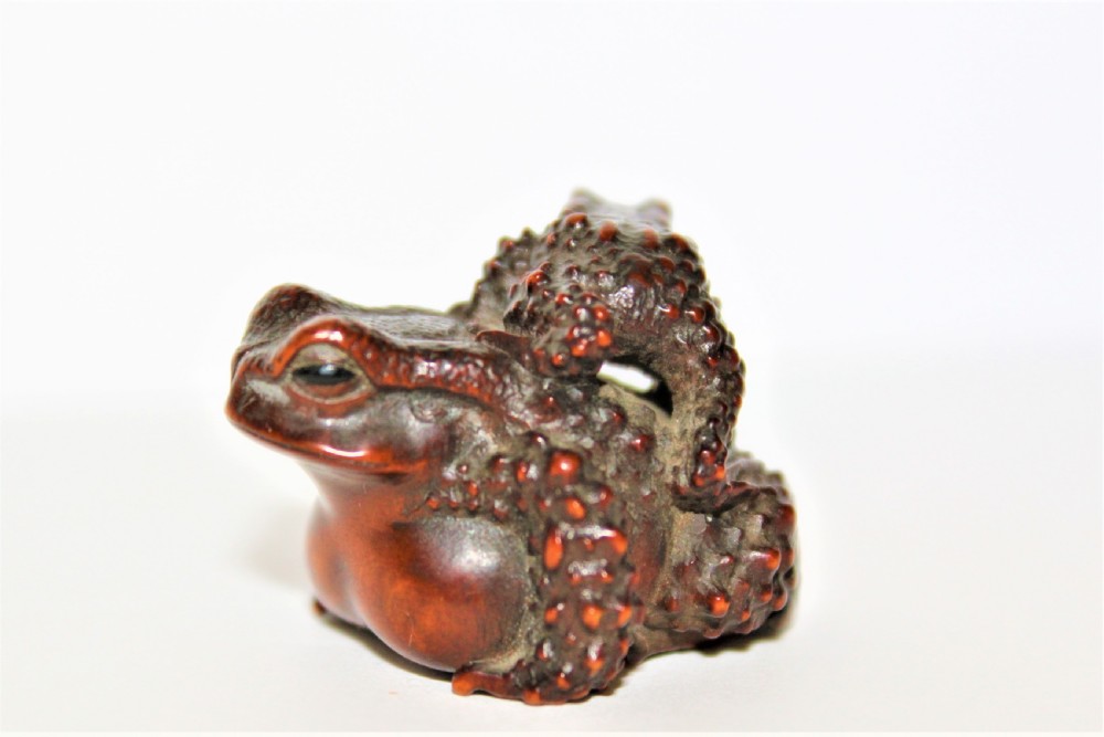 A finely carved small boxwood netsuke /okimono of two Toads signed Masanao View III