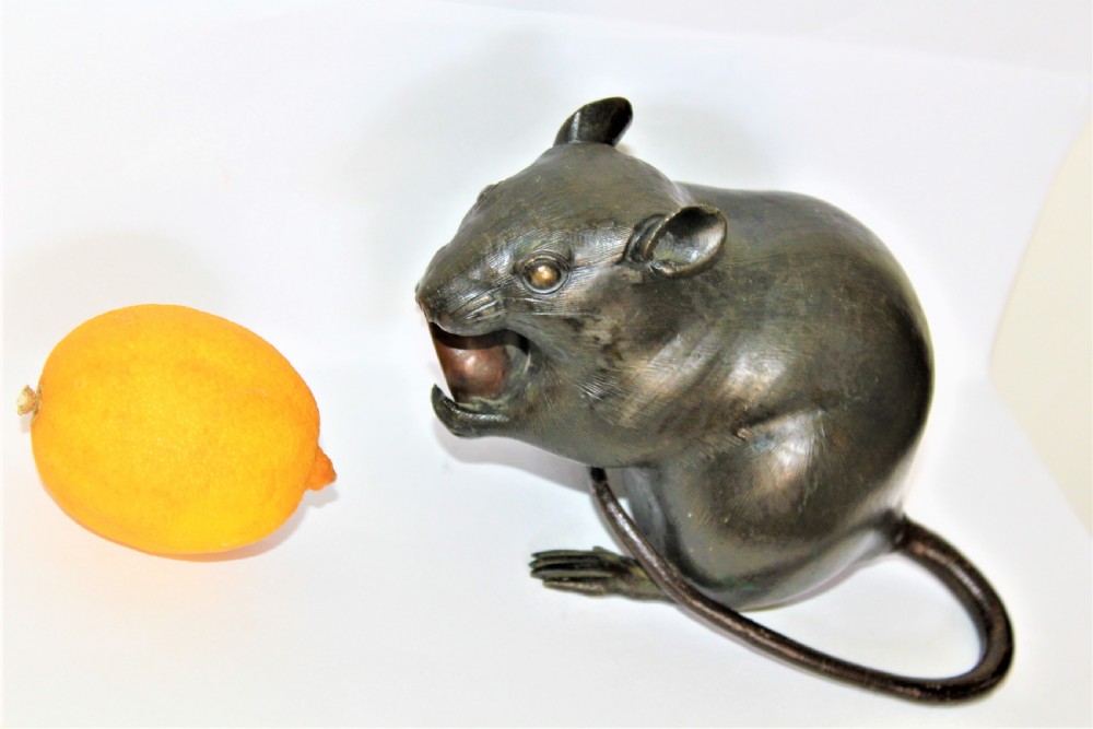 A well defined and chunky Japanese bronze model of a rodent and signed View II