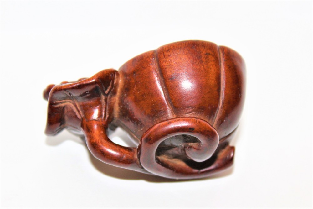 Finely carved boxwood netsuke of a Lotus Seed Pod with toad  View II