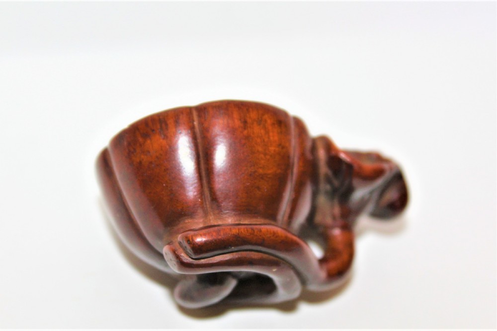 Finely carved boxwood netsuke of a Lotus Seed Pod with toad  View III