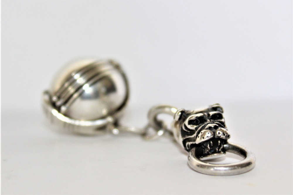 An interesting and unusual silver fob depicting a dogs head and ball  View II