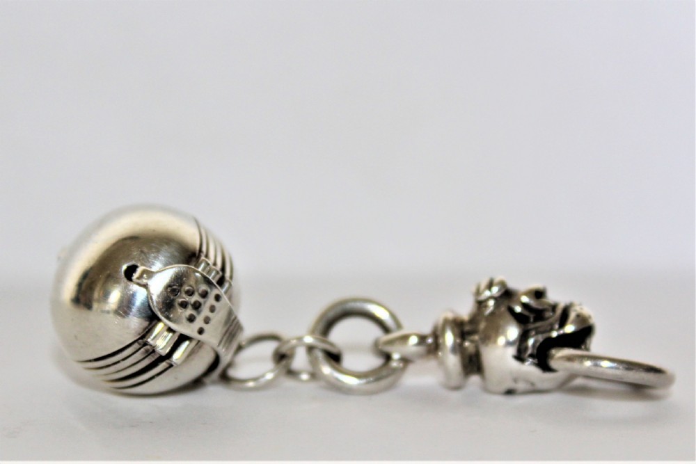 An interesting and unusual silver fob depicting a dogs head and ball  View IV