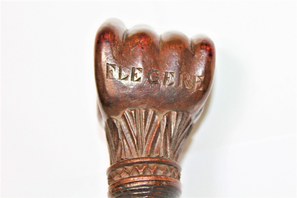 A dark brown hand-carved wooden screw-action nutcracker shaped as a clenched fist. View V