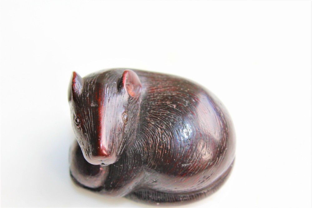 A finely carved wood netsuke modelled as a rodent View III