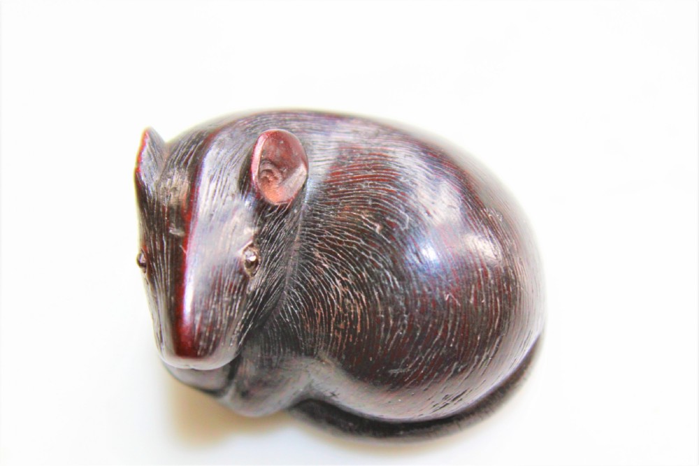 A finely carved wood netsuke modelled as a rodent View IV