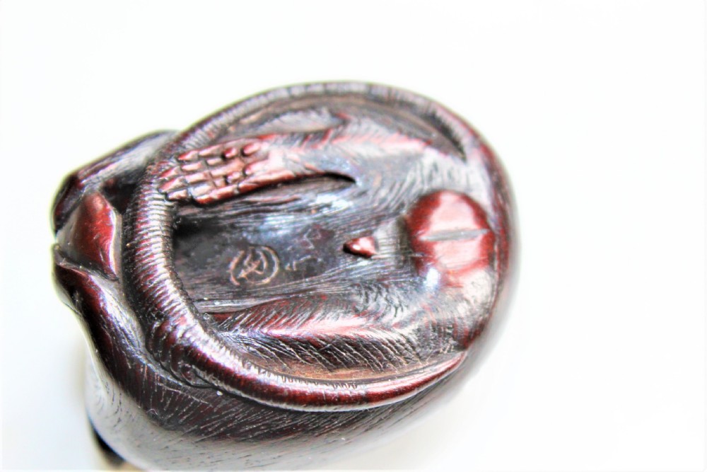 A finely carved wood netsuke modelled as a rodent View V