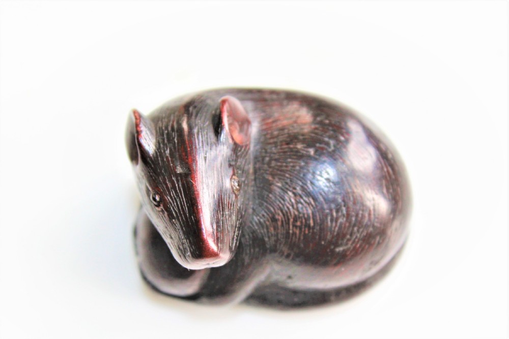 A finely carved wood netsuke modelled as a rodent View VII