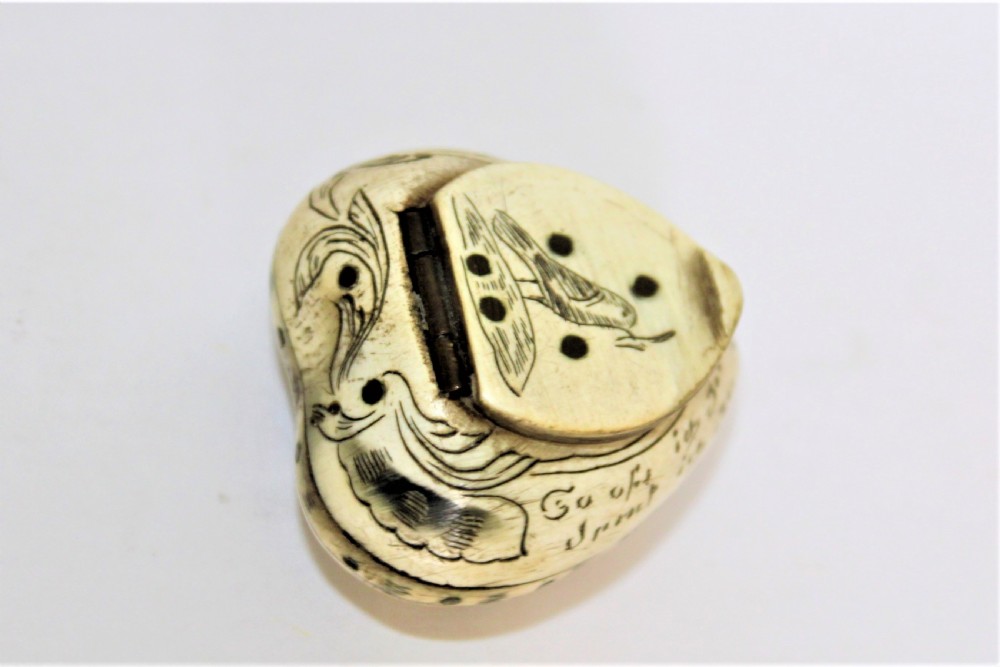 A 19th century small heart shaped horn box, possibly a love token  View II