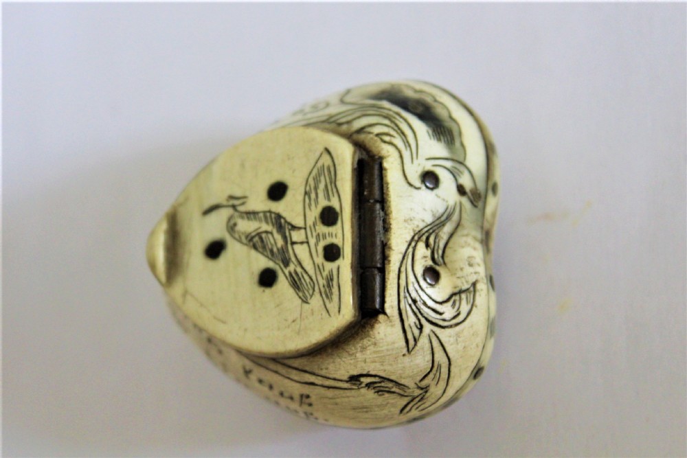A 19th century small heart shaped horn box, possibly a love token  View VI