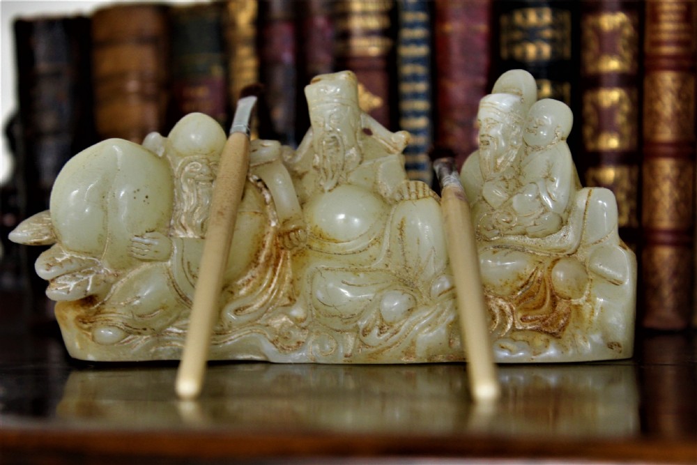 A finely carved Chinese hardstone possibly jade figural brush rest  View II