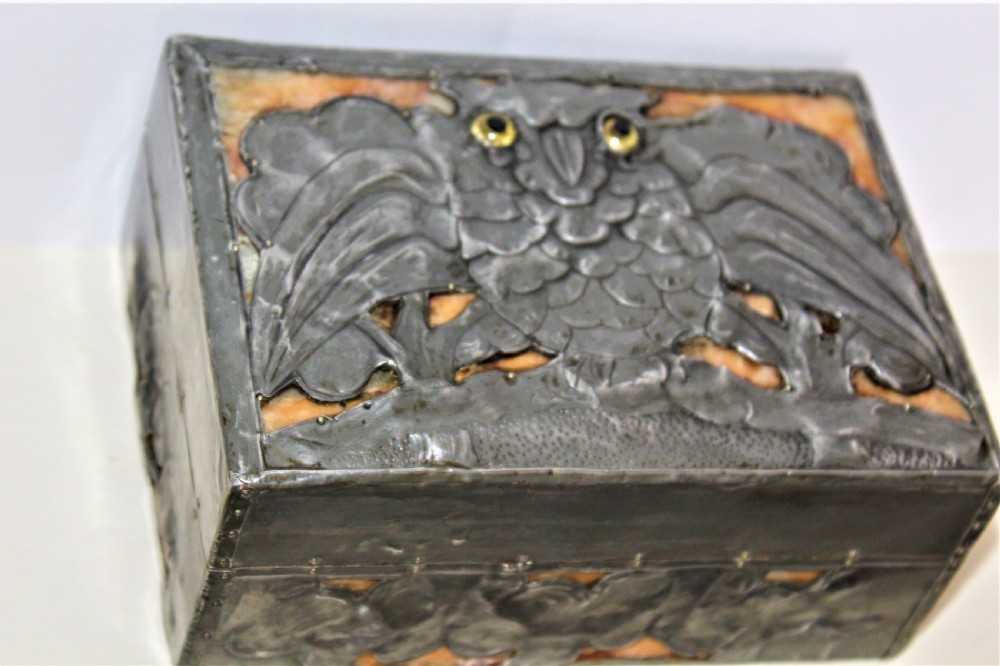 A rectangular Arts and Crafts pewter box featuring a raised repousse owl design with yellow glass eyes on the lid. View II