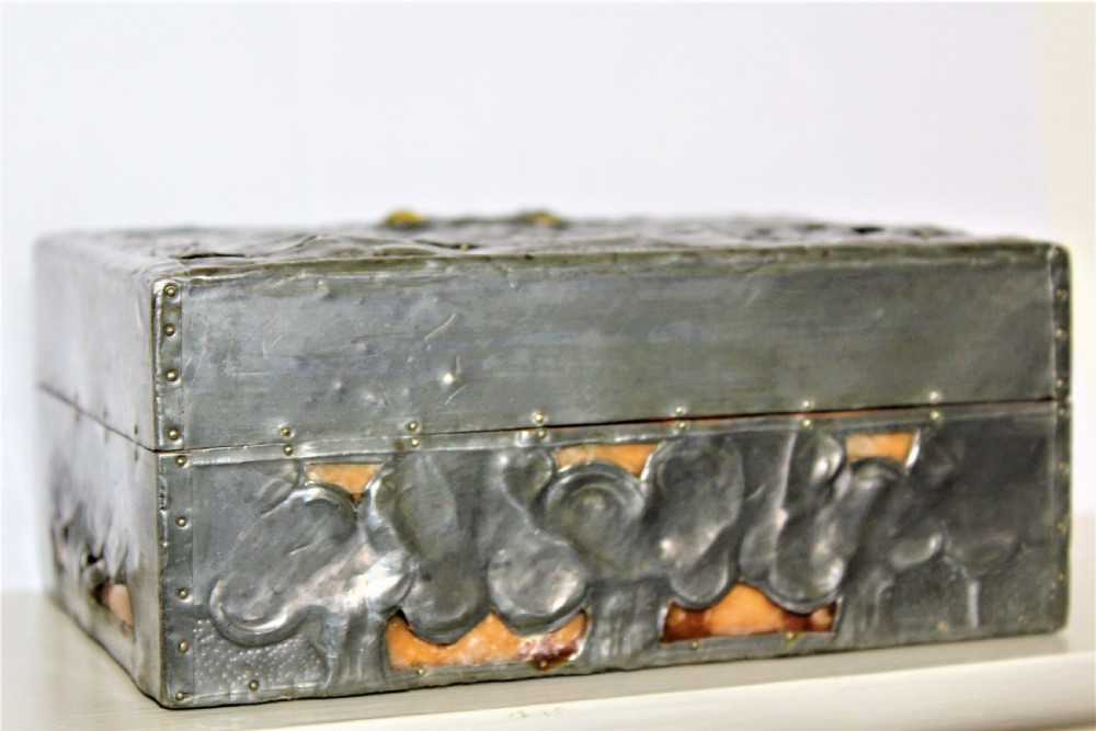 A rectangular Arts and Crafts pewter box featuring a raised repousse owl design with yellow glass eyes on the lid. View IV