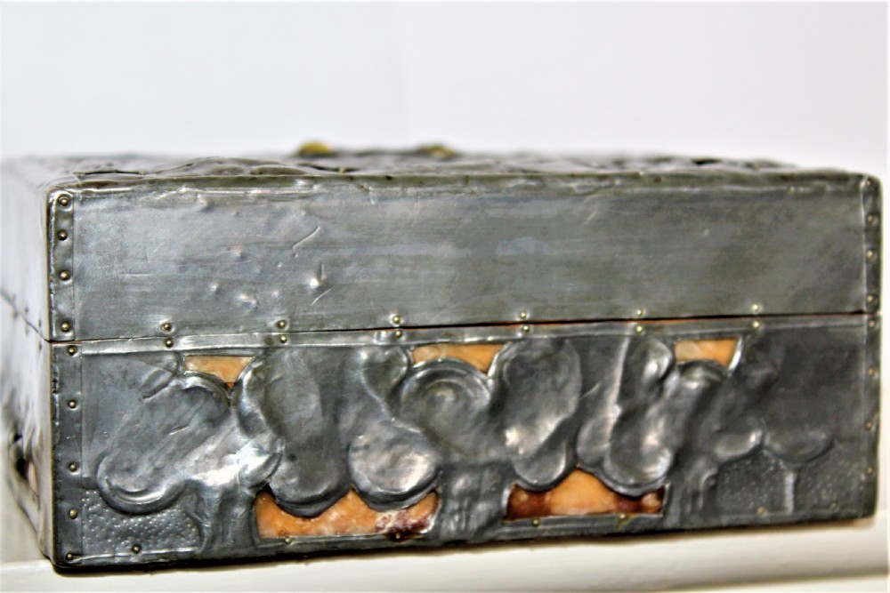 A rectangular Arts and Crafts pewter box featuring a raised repousse owl design with yellow glass eyes on the lid. View V