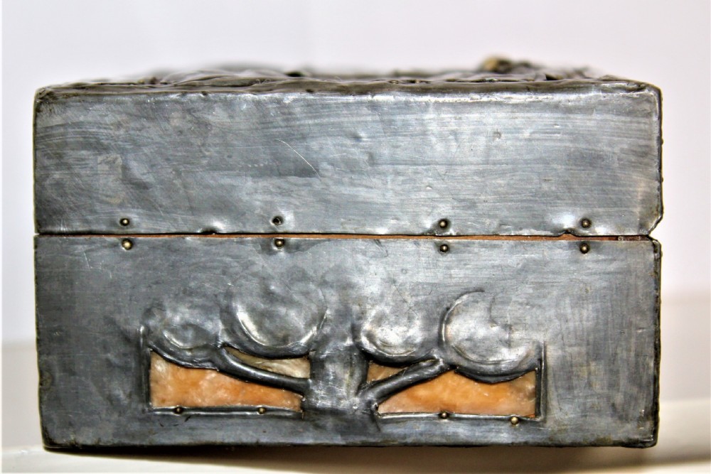 A rectangular Arts and Crafts pewter box featuring a raised repousse owl design with yellow glass eyes on the lid. View VI