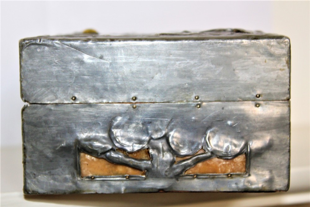 A rectangular Arts and Crafts pewter box featuring a raised repousse owl design with yellow glass eyes on the lid. View VII