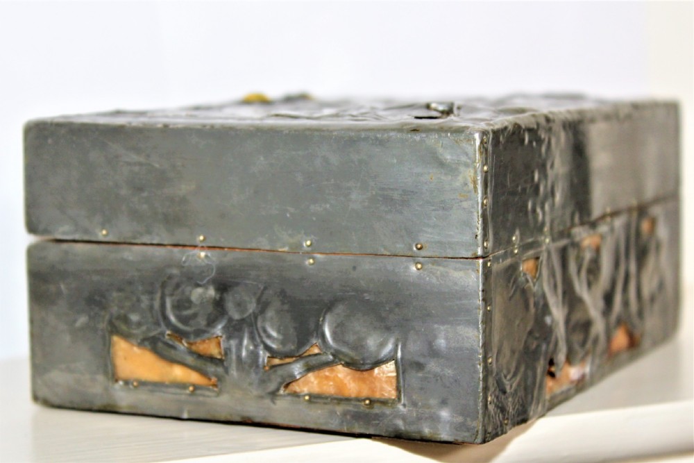 A rectangular Arts and Crafts pewter box featuring a raised repousse owl design with yellow glass eyes on the lid. View VIII