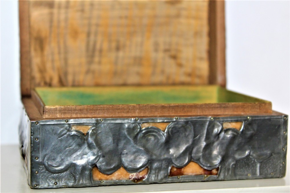 A rectangular Arts and Crafts pewter box featuring a raised repousse owl design with yellow glass eyes on the lid. View IX