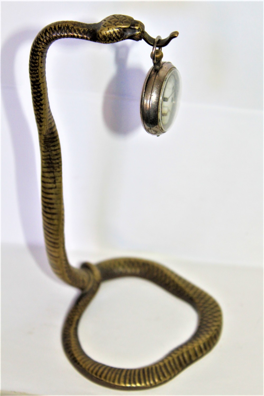 A tall and very stylish bronze / brass watch stand 