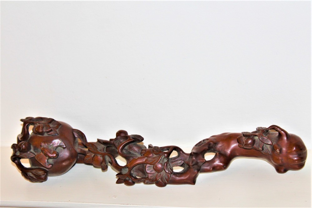A hand-carved boxwood Ruyi sceptre featuring naturalistic branches, leaves, and peach motifs. View III