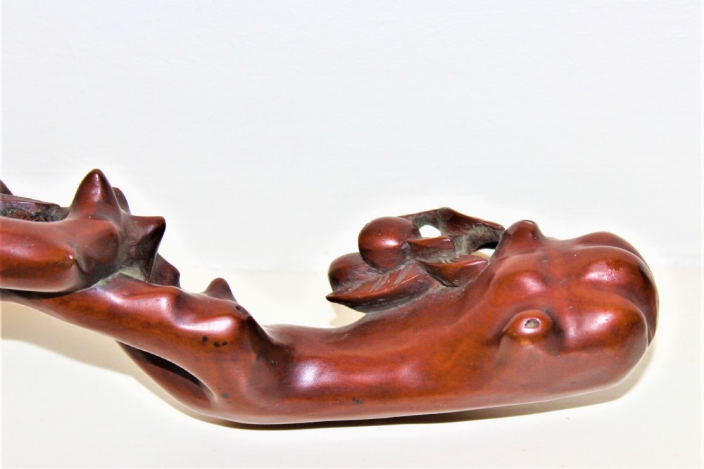 A hand-carved boxwood Ruyi sceptre featuring naturalistic branches, leaves, and peach motifs. View IV