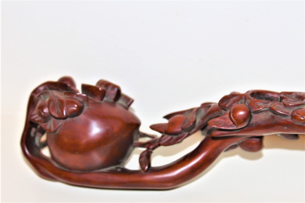 A hand-carved boxwood Ruyi sceptre featuring naturalistic branches, leaves, and peach motifs. View V