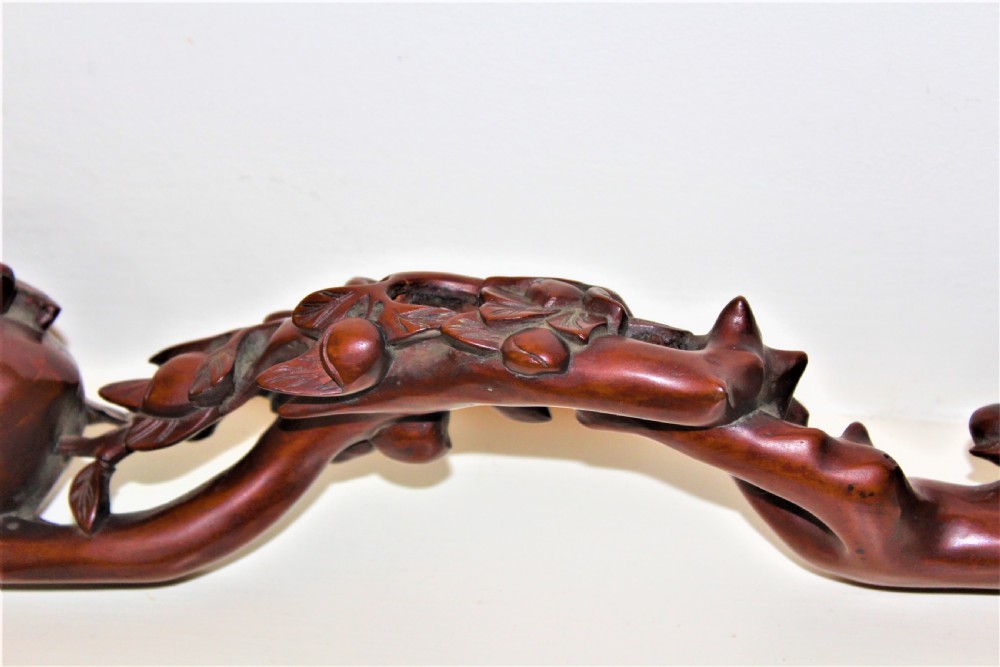 A hand-carved boxwood Ruyi sceptre featuring naturalistic branches, leaves, and peach motifs. View VI