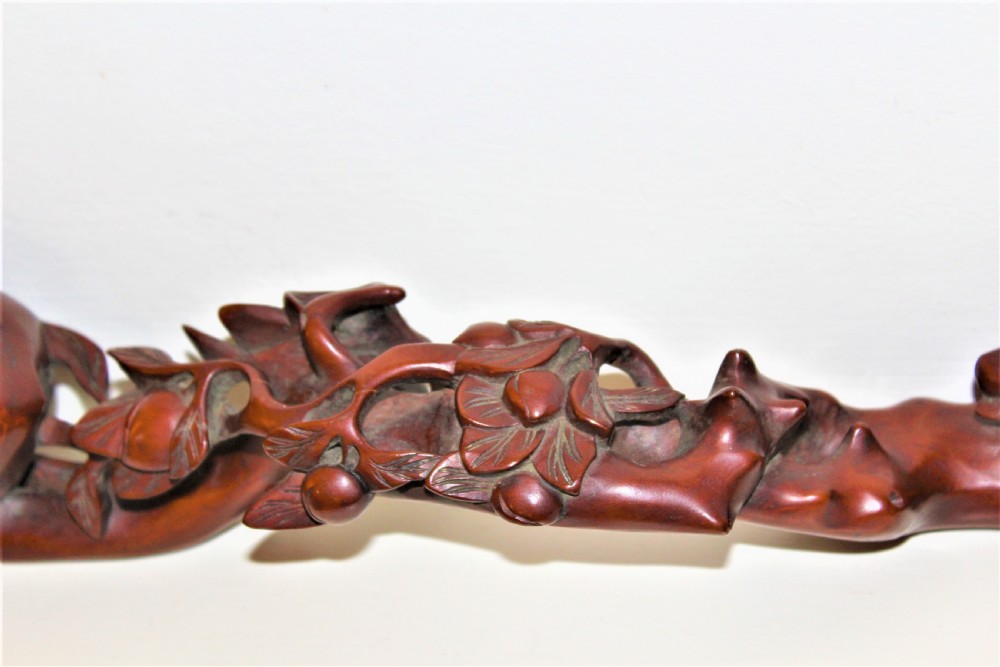 A hand-carved boxwood Ruyi sceptre featuring naturalistic branches, leaves, and peach motifs. View VIII