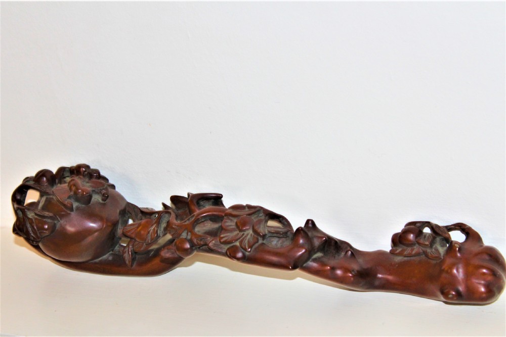A hand-carved boxwood Ruyi sceptre featuring naturalistic branches, leaves, and peach motifs. View IX